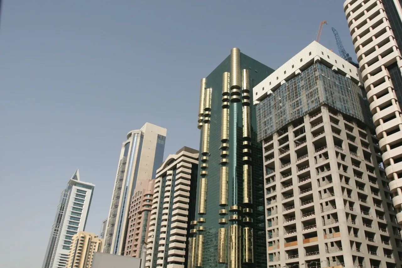 Commercial towers lining a main road, their frontages facing the traffic