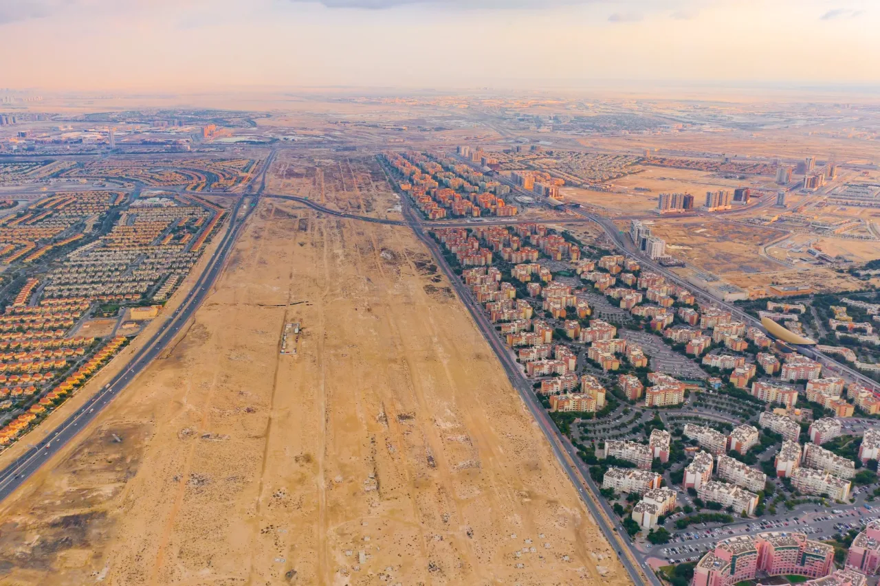 Aerial view of an open development corridor running between two built-up residential districts
